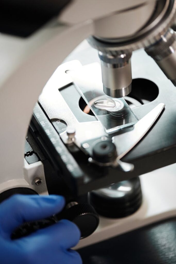 Detailed close-up view of a microscope examining a slide with precision instruments.